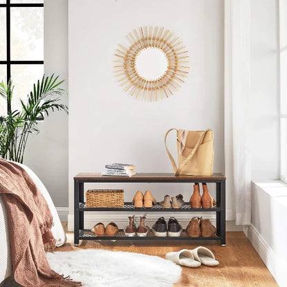 Rustic 3-tier wooden shoe organizer bench styled at the foot of a bed holding shoes, basket, and handbag in a modern bedroom.