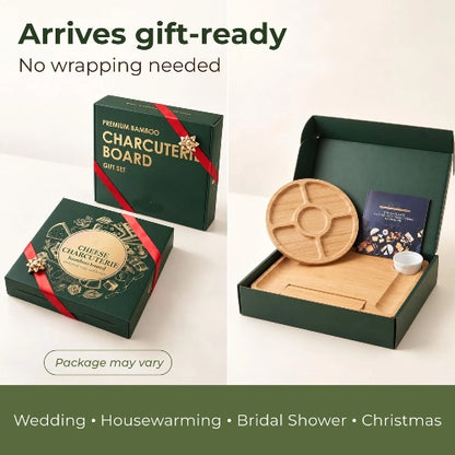 Gift-ready dark green presentation box containing square bamboo charcuterie board, round fruit platter, and ceramic bowl with red ribbon accents.