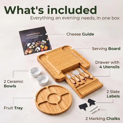 Product layout showing what is included: bamboo serving board with cutlery drawer, round fruit tray, 2 ceramic bowls, cheese utensils, slate labels, and marking chalks.