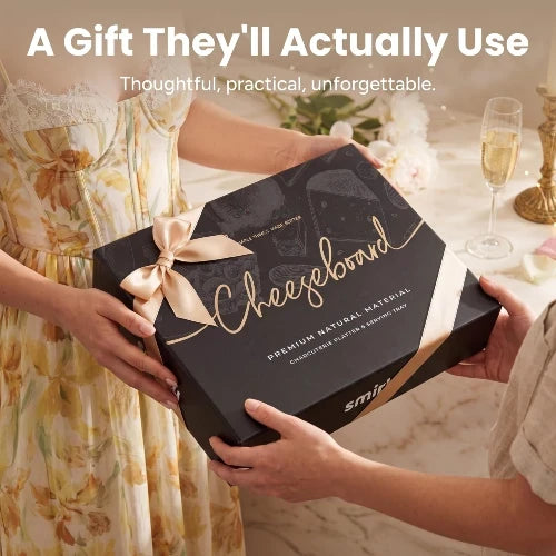 Elegant black gift box with gold ribbon for the NovoBam bamboo charcuterie board set being presented as a housewarming and wedding gift