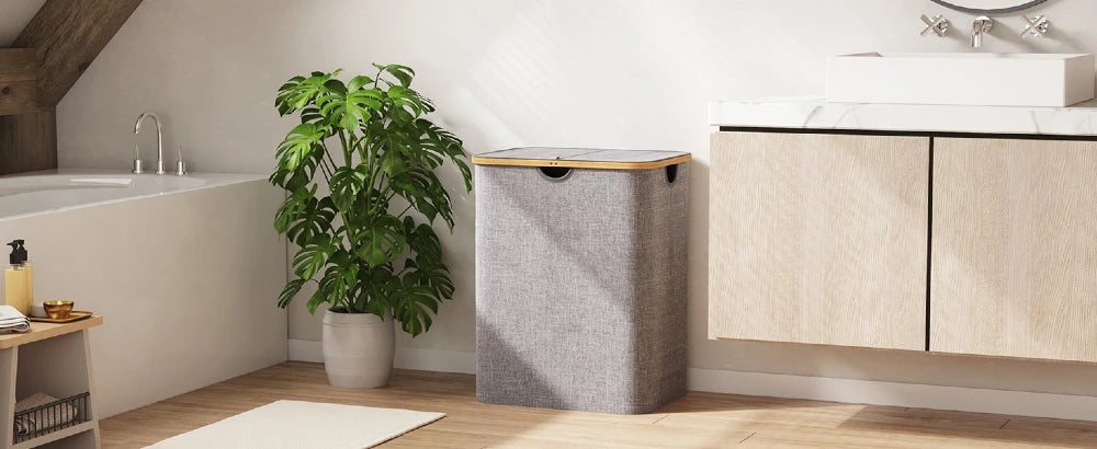 120L foldable laundry hamper with lid and bamboo handles placed beside bathtub and vanity in modern bathroom