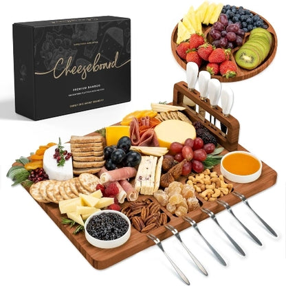 NovoBam dark brown wood finish charcuterie board set featuring a matching round fruit tray, magnetic knife block with four white knives, ceramic dipping bowls, and tasting forks fully arranged with party appetizers
