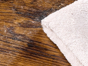 NovoBam shoe rack easy-to-clean rustic wood top surface being wiped clean with a microfiber cloth for effortless maintenance