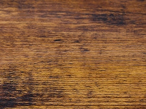 Close up of NovoBam shoe rack premium rustic veneered particleboard wooden top shelf showcasing detailed wood grain texture and durable finish