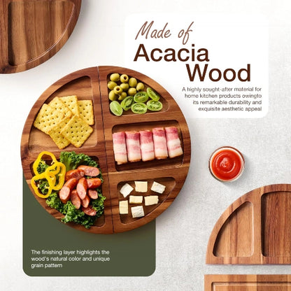 Round natural acacia wood divided serving platter arranged with crackers, olives, cheese cubes, cured meats, and dipping sauce.