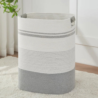 Tall rectangular woven cotton rope laundry hamper in gray and white stripes with gray handles, standing upright on a rug.